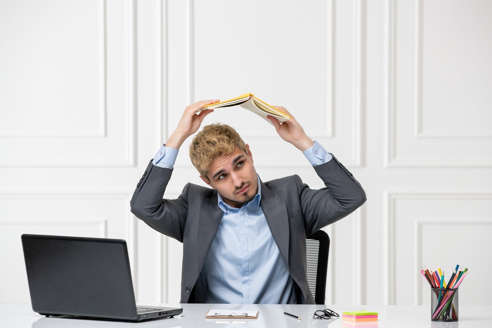 ADHD cute young stressed worker in the office behind desk with computer doing silly stuff